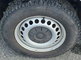 a white truck with a flat tire on the road