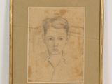 dessin représentant le visage d'une femme dans un cadre doré sur un mur blanc