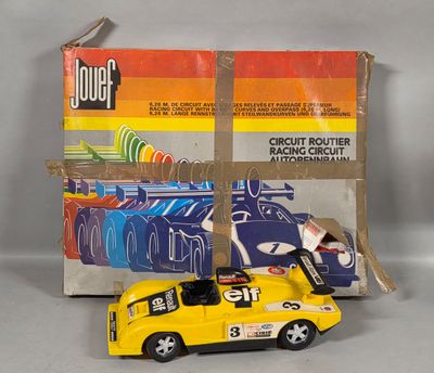 a yellow toy car that is sitting next to a box
