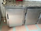 a kitchen with a refrigerator and a toaster on the counter
