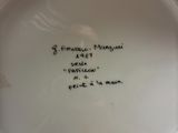 a white plate with writing on it on a table