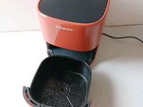 an orange and black electric fryer sitting on a counter