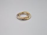 a close up of a gold and silver ring on a white surface