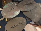 a pile of metal tags that are on a table