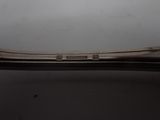 a close up of a silver spoon on a white surface