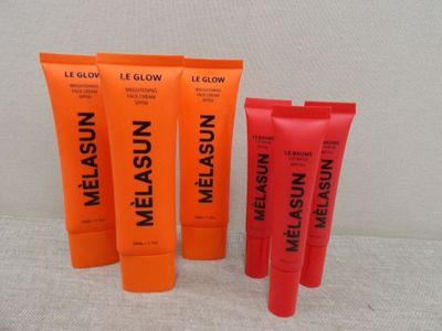 a close up of three tubes of melasun and a tube of melasun