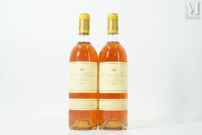 two bottles of wine sitting next to each other on a white surface