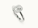 an emerald and diamond ring on a white background