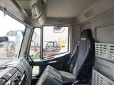 a seat in the back of a truck with a view of the street