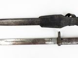 pair of old knives on a white surface with a knife in the middle