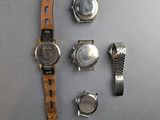 a lot of watches that are laying out on the table
