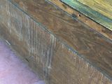 a wooden box sitting on the floor next to a wall