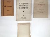 several books are sitting on a table with a white table cloth