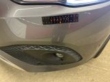 a close up of a car ' s tail light with a sticker on it