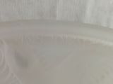 a close up of a white bowl with a bird on it