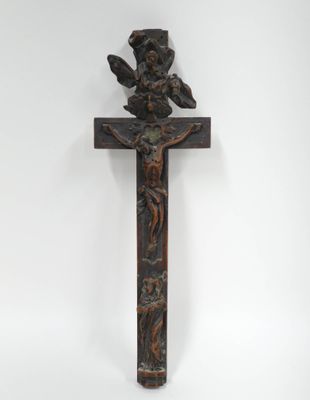 une croix en bois surmontée d'un oiseau, sur fond blanc