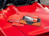 a red sports car with books on top of it