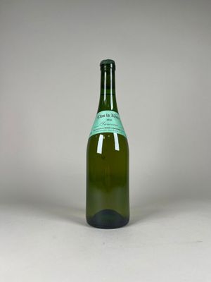 an empty bottle of wine sitting on top of a white table