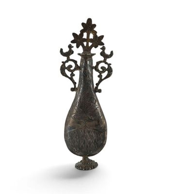 an image of a metal vase with flowers on it on a white background