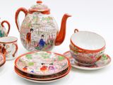 a tea set with a teapot, cups, and saucers