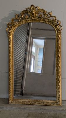 a mirror that is sitting on the floor next to a wall