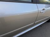 a silver car that is parked on the side of the road