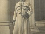 an old photo of a man in a white coat and hat