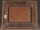 an old wooden picture frame with a tag on it