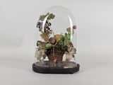 a glass clochet with a plant inside of it