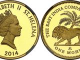 a gold coin with a lion and palm tree on it