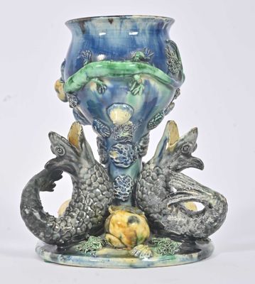 a blue vase with a dragon and a ball on it