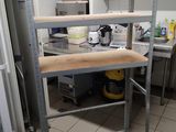 a kitchen area with a stove, sink, and shelves