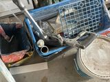 a blue basket with tools in it sitting on the floor