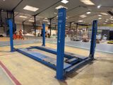 a large blue machine in the middle of a warehouse