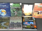several books are sitting on a table next to each other