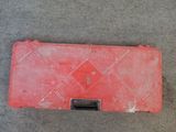 a red case that is laying on the floor