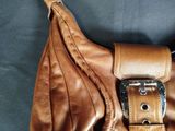 a brown leather purse with a metal buckle on it