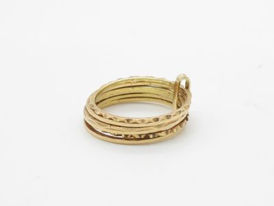 a close up of a gold ring on a white surface