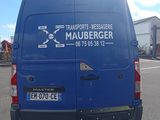 a blue van that is parked in a parking lot
