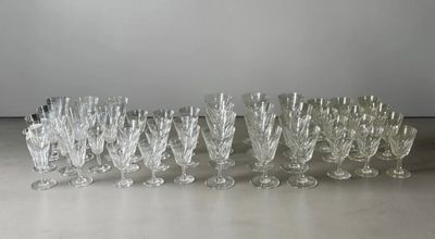 douze verres à vin en cristal alignés sur une table