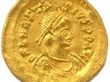 une pièce d'or à l'effigie d'un homme coiffé d'une couronne