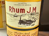 a bottle of rum in front of a box of liquor