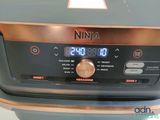 a close up of a kitchen appliance with a clock on it