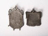 pair of antique silver metal mesh purses on a white background