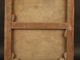 an old wooden easel with a blank canvas on a black background