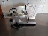 an image of a meat slicer on a counter top