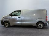 the silver van is parked in the garage with its door open