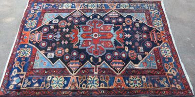 rug on the floor is blue and red with a design on it