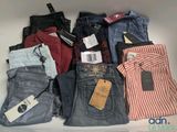 several pairs of men ' s jeans are stacked on top of each other