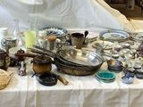 a table that has a lot of silver items on it